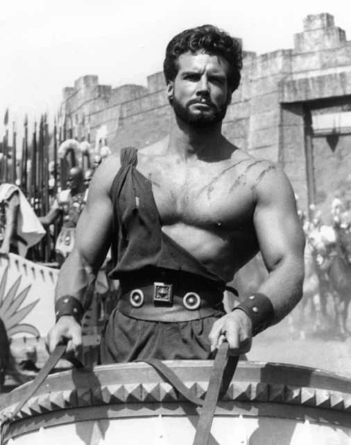 Black and white film still of Steve Reeves as Hercules in a chariot
