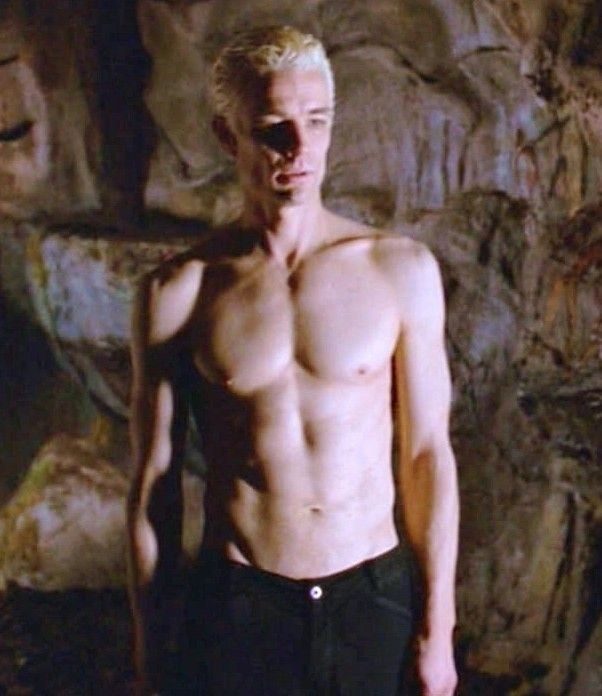 Spike from Buffy the Vampire Slayer, shirtless with bleached hair, in a cave