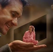 A man holding his tiny wife in pink pyjamas on the palm of his hand
